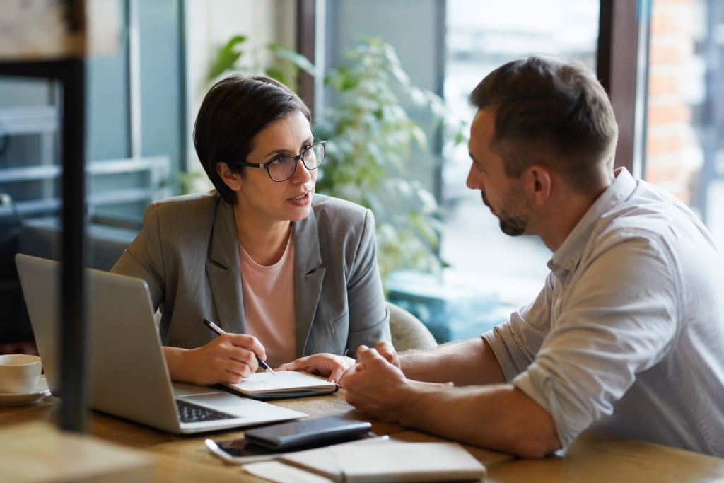 Business owner and specialist advisor discussing growth strategy together